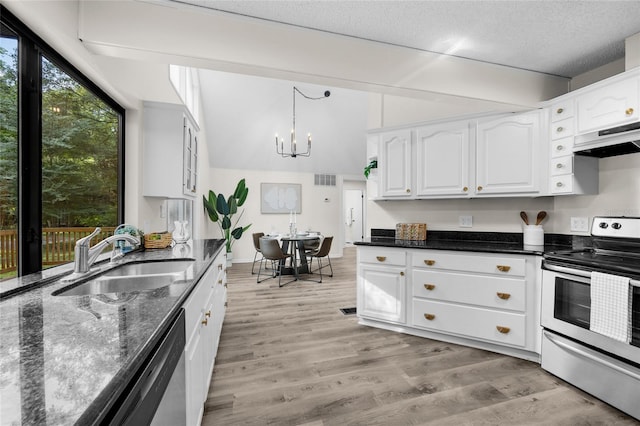 2101 SW 79th Dr, Gainesville, FL 32607 - kitchen with appliances with stainless steel finishes, dark stone counters, a chandelier, white cabinets, and range hood