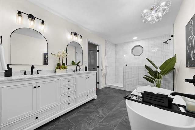 2101 SW 79th Dr, Gainesville, FL 32607 - bathroom featuring double vanity, walk in shower, a freestanding tub, recessed lighting, and a chandelier