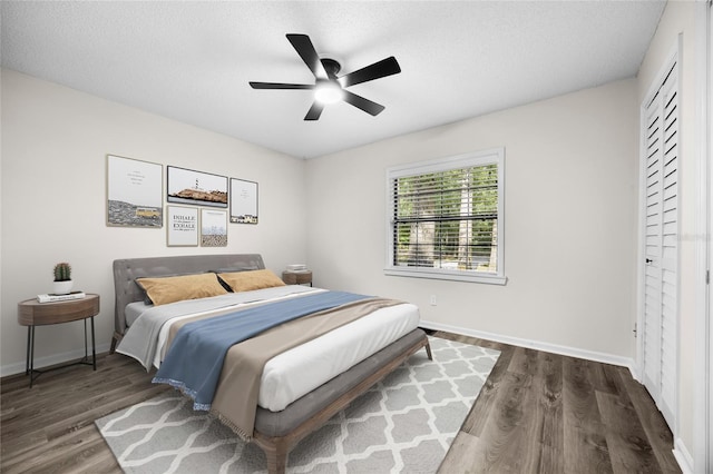 2101 SW 79th Dr, Gainesville, FL 32607 - bedroom with dark wood-style floors, ceiling fan, and a textured ceiling