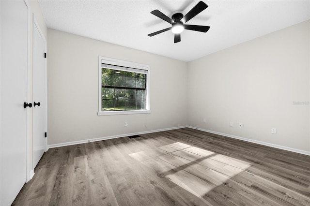 2101 SW 79th Dr, Gainesville, FL 32607 - empty room with wood finished floors and a ceiling fan