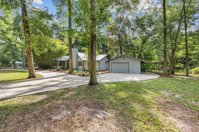 2101 SW 79th Dr, Gainesville, FL 32607 - view of front of home featuring driveway, a front yard, a detached garage, and a chimney