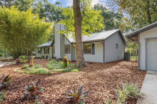 2101 SW 79th Dr, Gainesville, FL 32607 - view of front facade featuring a standing seam roof, a metal roof, and a chimney