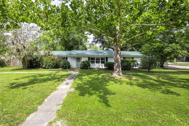 5022 NW 34th Ter, Gainesville, FL 32605 - ranch-style house featuring a front lawn, driveway, and a metal roof