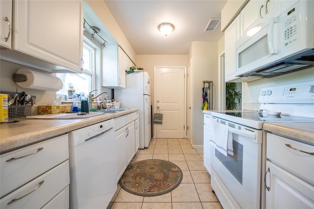 5022 NW 34th Ter, Gainesville, FL 32605 - kitchen with white appliances, white cabinets, and light countertops