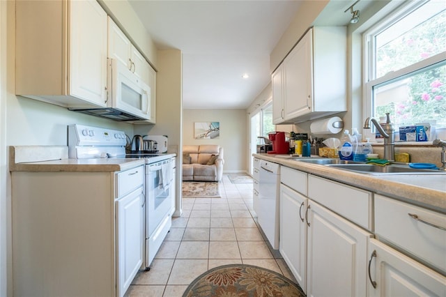 5022 NW 34th Ter, Gainesville, FL 32605 - kitchen with white appliances, light countertops, white cabinetry, light tile patterned floors, and recessed lighting