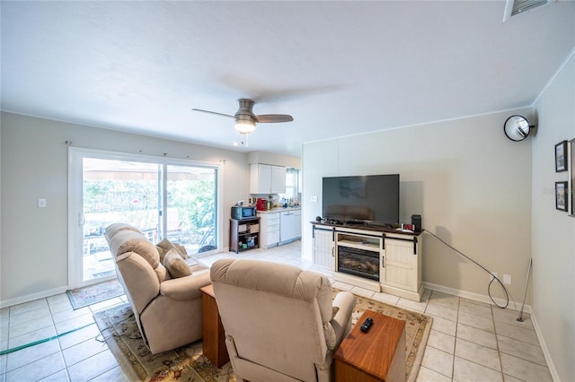 5022 NW 34th Ter, Gainesville, FL 32605 - living area featuring light tile patterned floors, ceiling fan, and a fireplace