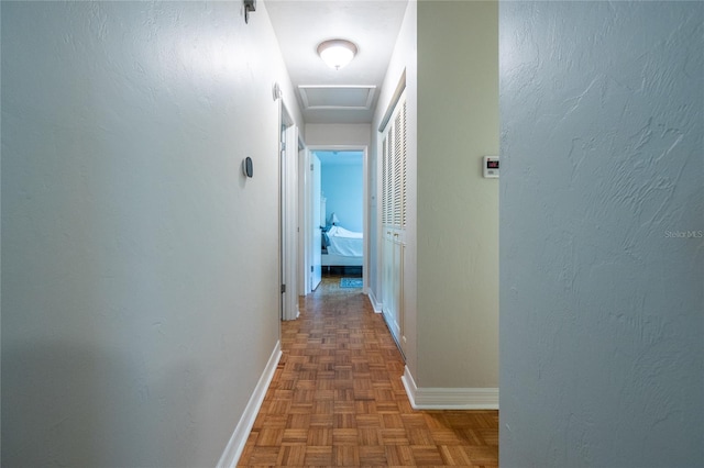 5022 NW 34th Ter, Gainesville, FL 32605 - hallway featuring baseboards and attic access