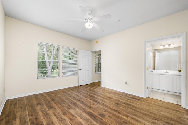 5133 SW 91st Ct Unit G202, Gainesville, FL 32608 - unfurnished bedroom featuring wood finished floors, ensuite bath, and a ceiling fan