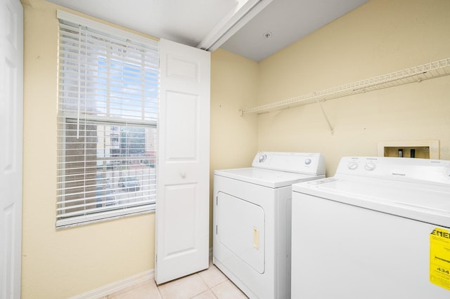 5133 SW 91st Ct Unit G202, Gainesville, FL 32608 - laundry area featuring washer and clothes dryer and light tile patterned flooring
