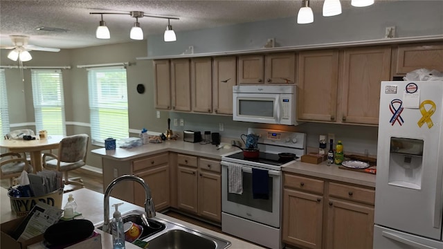 32932 Crooked Oaks Ln, Leesburg, FL 34748 - kitchen featuring white appliances, a peninsula, ceiling fan, light countertops, and a textured ceiling