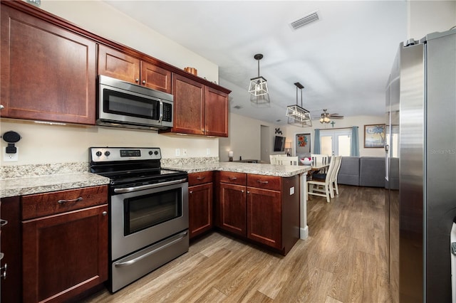 25111 SW 6th Ln, Newberry, FL 32669 - kitchen featuring appliances with stainless steel finishes, a peninsula, light wood-type flooring, open floor plan, and ceiling fan