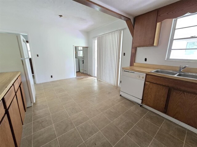 18248 High Springs Main St, High Springs, FL 32643 - kitchen with dishwasher, light countertops, brown cabinetry, and washer / clothes dryer