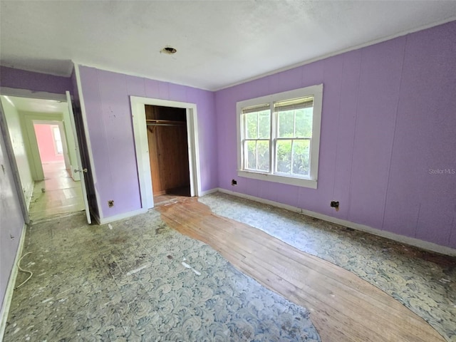 18248 High Springs Main St, High Springs, FL 32643 - unfurnished bedroom with wood finished floors, a closet, and a decorative wall