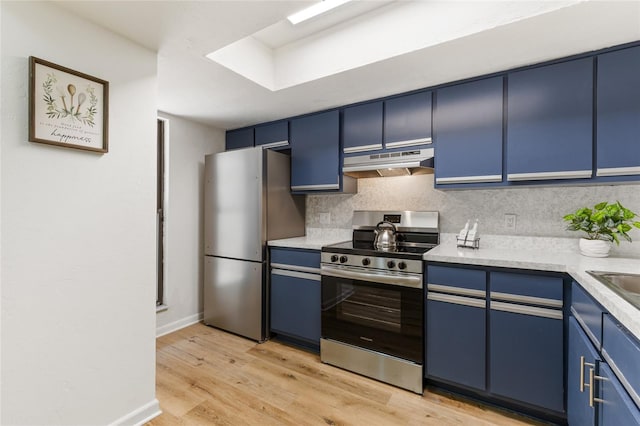 303 SW 54th Dr, Gainesville, FL 32607 - kitchen featuring stainless steel appliances, blue cabinetry, under cabinet range hood, tasteful backsplash, and light wood-style flooring