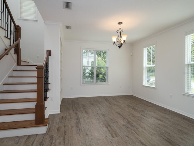 441 SW 129th Ter, Newberry, FL 32669 - unfurnished living room featuring stairway, wood finished floors, a chandelier, and ornamental molding