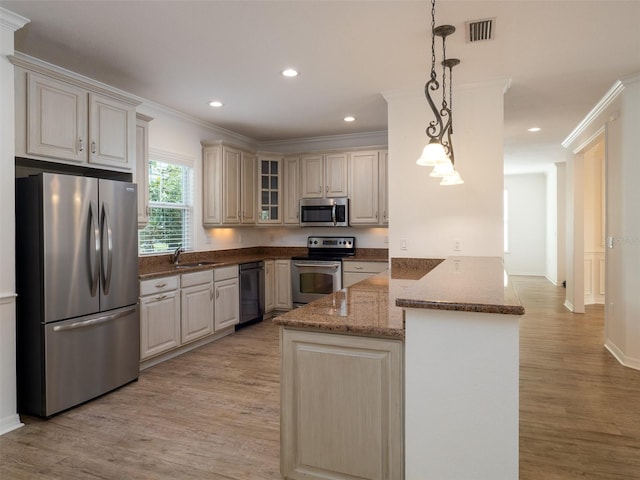 441 SW 129th Ter, Newberry, FL 32669 - kitchen featuring appliances with stainless steel finishes, a peninsula, light wood-style floors, glass insert cabinets, and dark stone counters