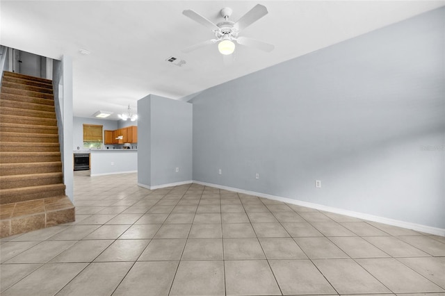 4415 SW 34th St Unit 107, Gainesville, FL 32608 - unfurnished living room with light tile patterned flooring, a chandelier, stairs, and a ceiling fan