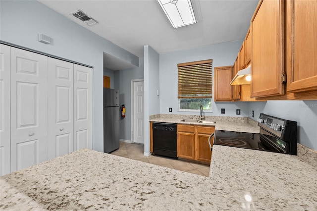 4415 SW 34th St Unit 107, Gainesville, FL 32608 - kitchen with appliances with stainless steel finishes, under cabinet range hood, light tile patterned floors, brown cabinetry, and light stone counters