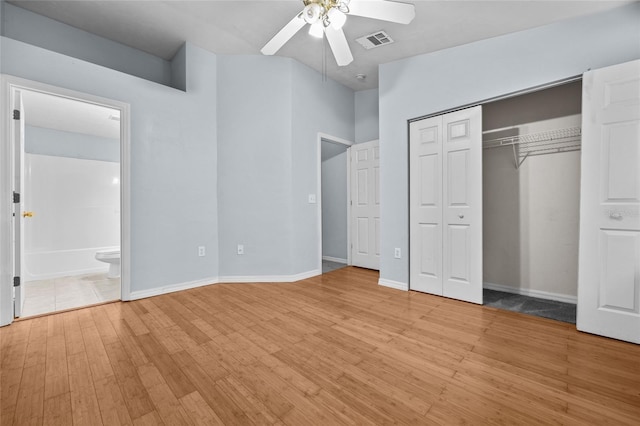 4415 SW 34th St Unit 107, Gainesville, FL 32608 - unfurnished bedroom featuring light wood-style floors, ensuite bathroom, a closet, and ceiling fan