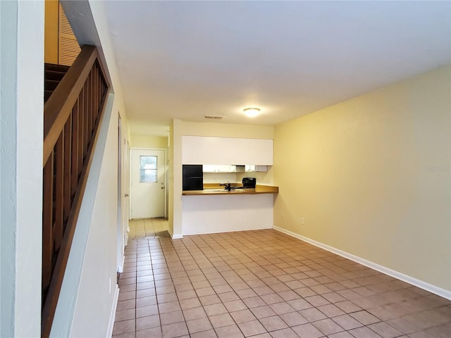 2207 SW 39th Dr, Gainesville, FL 32607 - unfurnished living room with light tile patterned flooring and baseboards