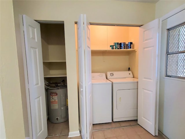 2207 SW 39th Dr, Gainesville, FL 32607 - washroom featuring electric water heater, light tile patterned floors, and washer and dryer