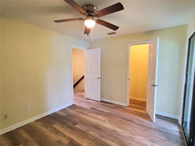 2207 SW 39th Dr, Gainesville, FL 32607 - unfurnished bedroom with wood finished floors and a ceiling fan