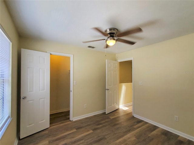 2207 SW 39th Dr, Gainesville, FL 32607 - unfurnished bedroom with dark wood-style floors, ceiling fan, and multiple windows
