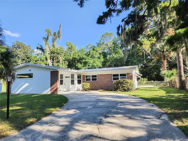 1601 NE 28th Ave, Gainesville, FL 32609 - view of front of property featuring driveway and brick siding