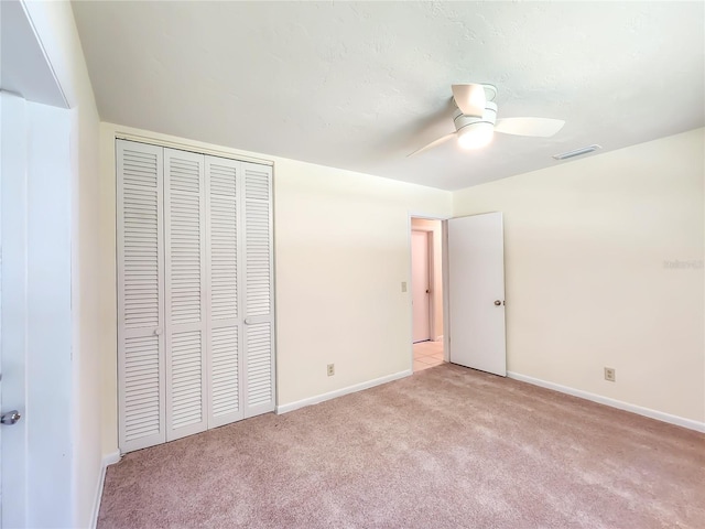 1601 NE 28th Ave, Gainesville, FL 32609 - unfurnished bedroom with light colored carpet, a closet, and ceiling fan