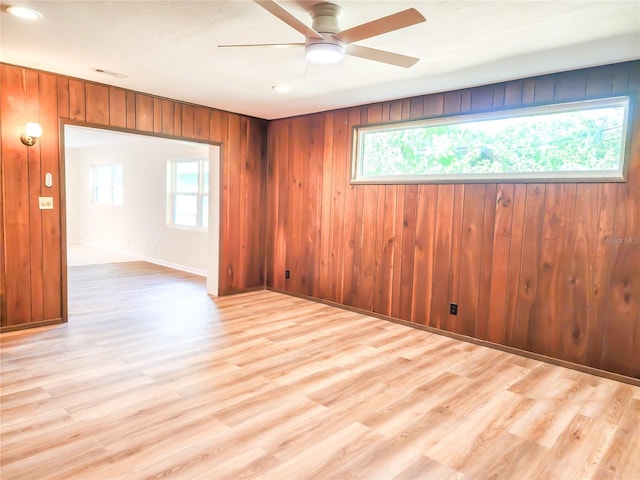 1601 NE 28th Ave, Gainesville, FL 32609 - empty room featuring a ceiling fan, wood finished floors, and wooden walls