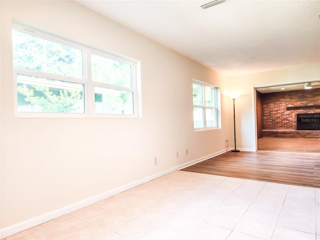 1601 NE 28th Ave, Gainesville, FL 32609 - unfurnished room featuring a fireplace and light wood finished floors