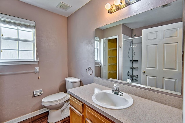 3701 NW 26th St, Gainesville, FL 32605 - bathroom featuring vanity, a shower, and wood finished floors
