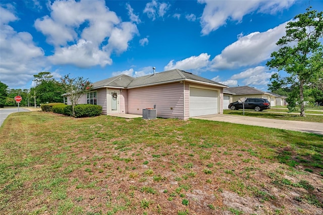 3701 NW 26th St, Gainesville, FL 32605 - view of property exterior with a garage, driveway, and a yard