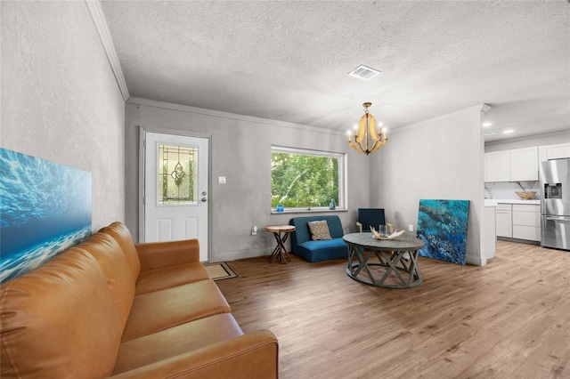 4923 SW Ichetucknee Ave, Fort White, FL 32038 - living room with crown molding, a chandelier, light wood finished floors, and a textured ceiling