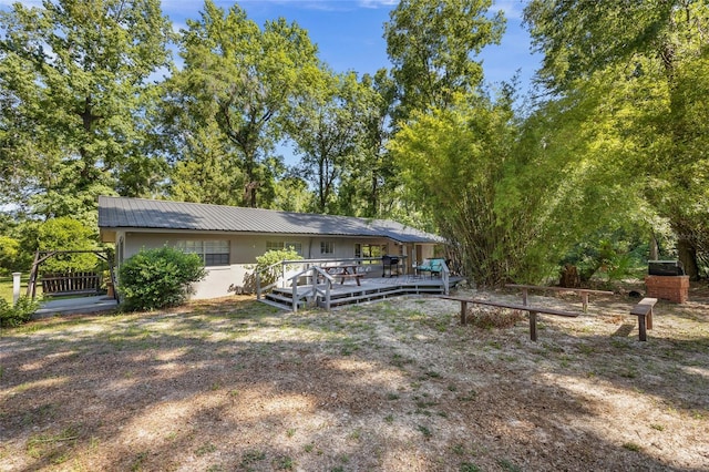 4923 SW Ichetucknee Ave, Fort White, FL 32038 - rear view of property featuring a deck and a metal roof