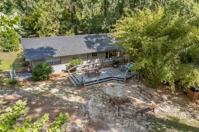 4923 SW Ichetucknee Ave, Fort White, FL 32038 - back of house with a wooden deck and a metal roof