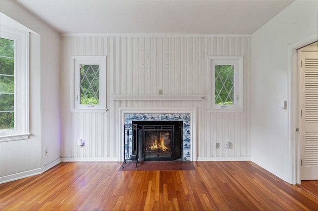2506 SW 9th Dr, Gainesville, FL 32601 - unfurnished living room featuring healthy amount of natural light, wood finished floors, a premium fireplace, and ornamental molding