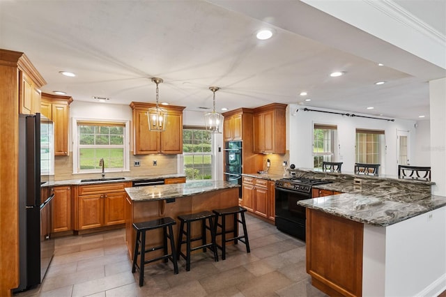 2506 SW 9th Dr, Gainesville, FL 32601 - kitchen featuring a breakfast bar, black appliances, a peninsula, recessed lighting, and decorative backsplash