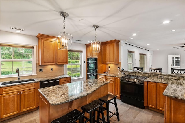 2506 SW 9th Dr, Gainesville, FL 32601 - kitchen featuring black appliances, decorative backsplash, stone counters, a breakfast bar, and recessed lighting