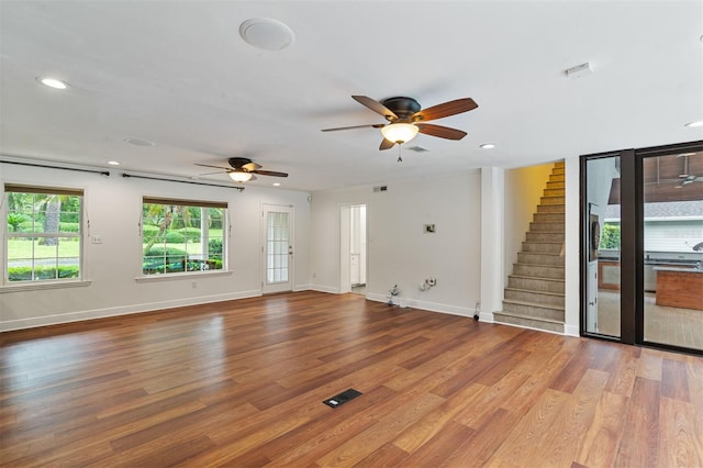 2506 SW 9th Dr, Gainesville, FL 32601 - unfurnished living room featuring ceiling fan, stairs, wood finished floors, and recessed lighting