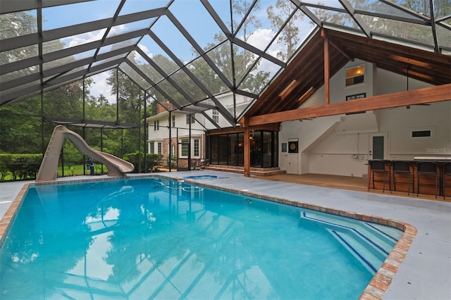 2506 SW 9th Dr, Gainesville, FL 32601 - outdoor pool with an in-ground hot tub, a water slide, a patio, and glass enclosure