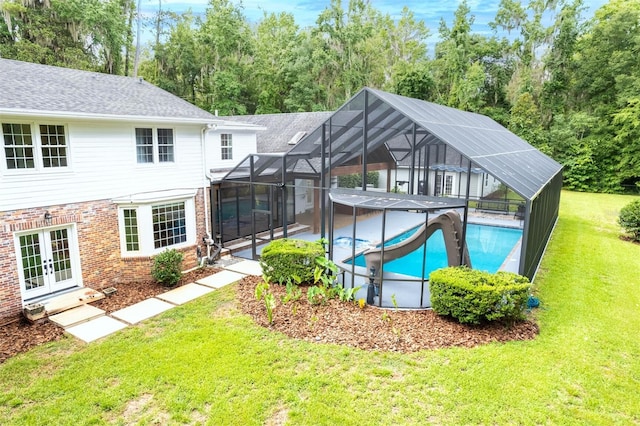 2506 SW 9th Dr, Gainesville, FL 32601 - swimming pool with french doors, a lawn, a patio area, and glass enclosure