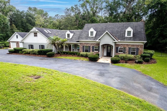 2506 SW 9th Dr, Gainesville, FL 32601 - cape cod-style house with brick siding, a front yard, a shingled roof, a garage, and driveway