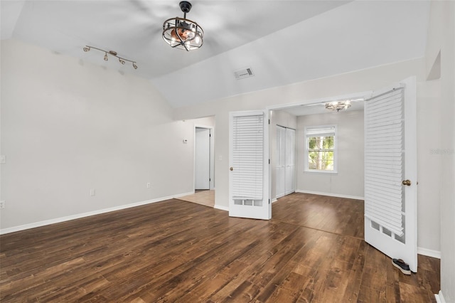 5328 SW 88th Ct, Gainesville, FL 32608 - spare room with vaulted ceiling, wood finished floors, and track lighting