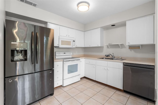 5328 SW 88th Ct, Gainesville, FL 32608 - kitchen with white appliances, light countertops, white cabinets, light tile patterned flooring, and open shelves