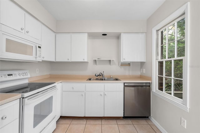 5328 SW 88th Ct, Gainesville, FL 32608 - kitchen with white appliances, light tile patterned floors, light countertops, and white cabinets
