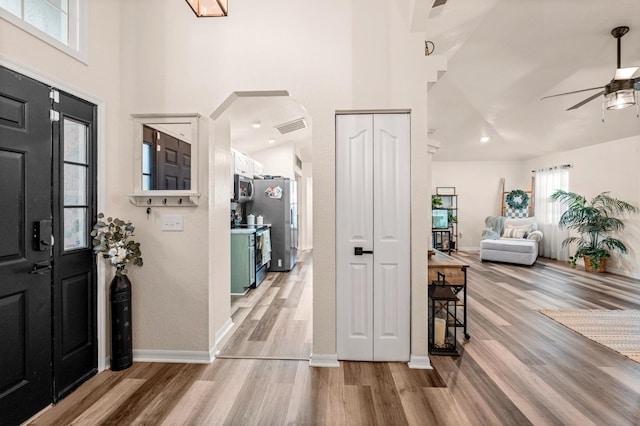 3292 NE 42nd Pl, Ocala, FL 34479 - entrance foyer featuring a ceiling fan, light wood finished floors, arched walkways, and a high ceiling