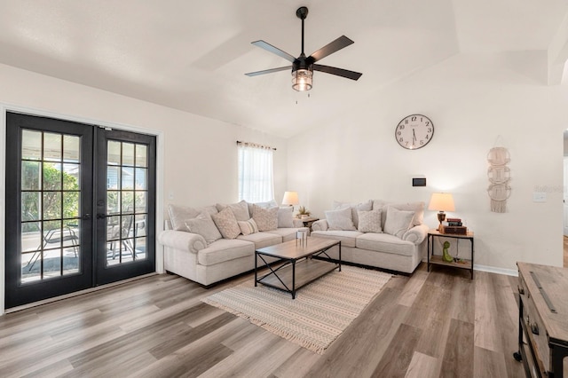 3292 NE 42nd Pl, Ocala, FL 34479 - living room with french doors, vaulted ceiling, wood finished floors, plenty of natural light, and ceiling fan