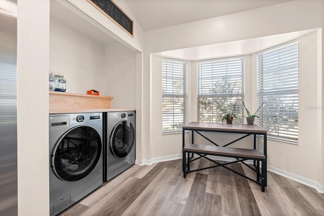 3292 NE 42nd Pl, Ocala, FL 34479 - laundry area with washing machine and clothes dryer and wood finished floors