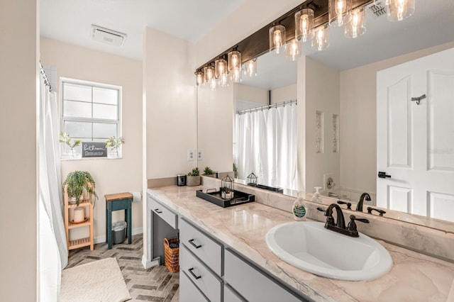 3292 NE 42nd Pl, Ocala, FL 34479 - bathroom with vanity and brick patterned floors